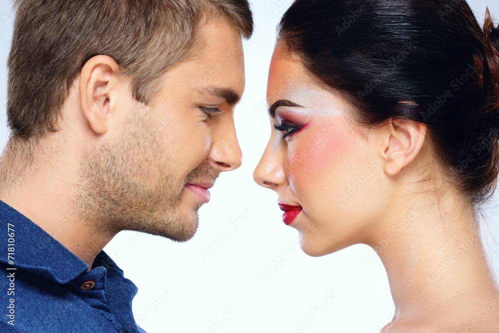Portrait of a young beautiful couple looking to each other Portrait of a young beautiful couple looking to each other