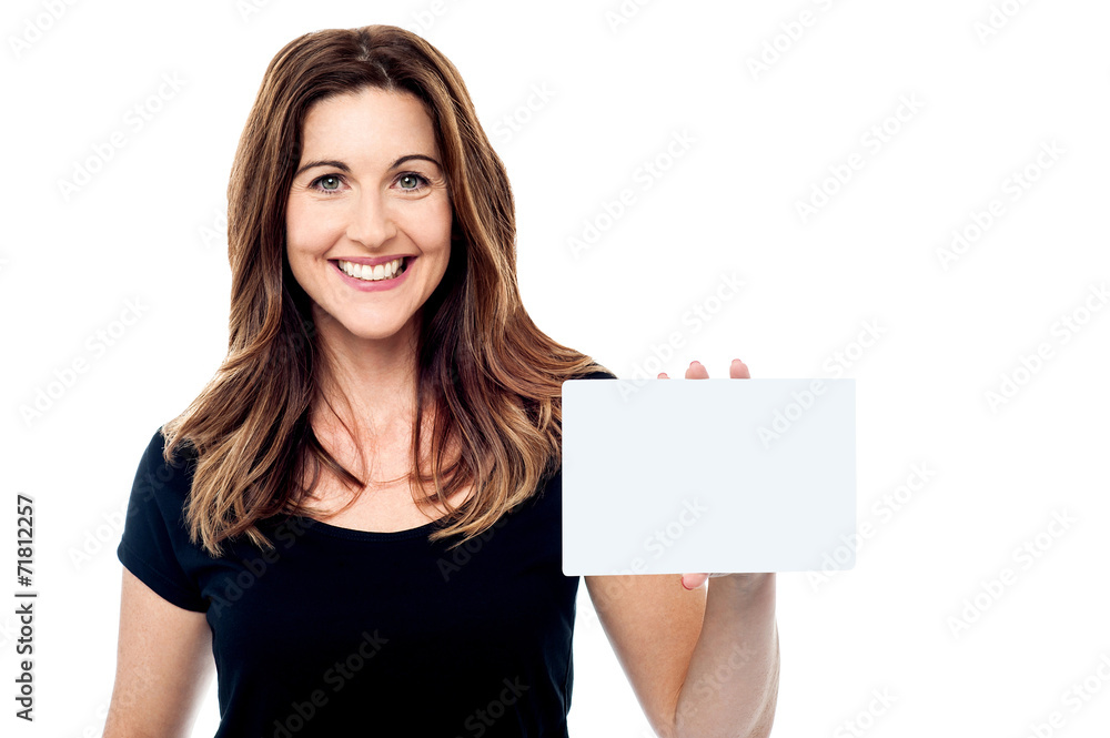 Attractive businesswoman holding a blank card Attractive businesswoman holding a blank card