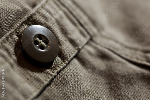 Close up of button on trousers