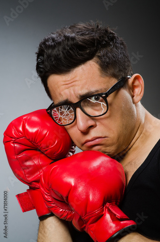 Funny boxer with red gloves against dark background © Elnur