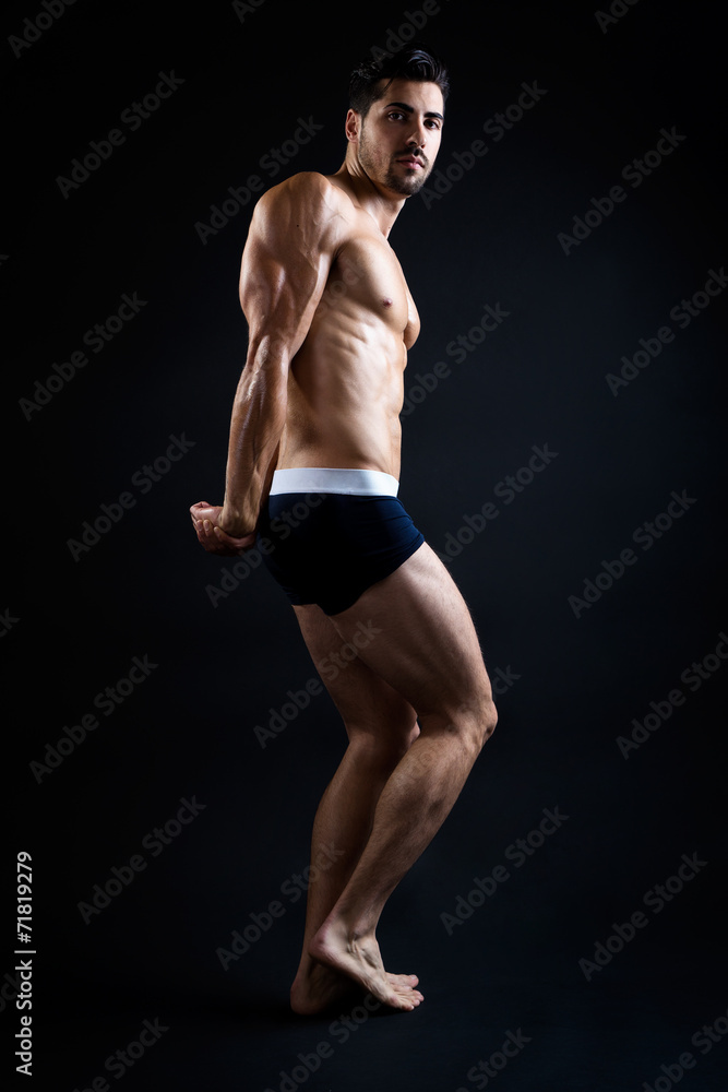 Beautiful and muscular man in dark background. Beautiful and muscular man in dark background.