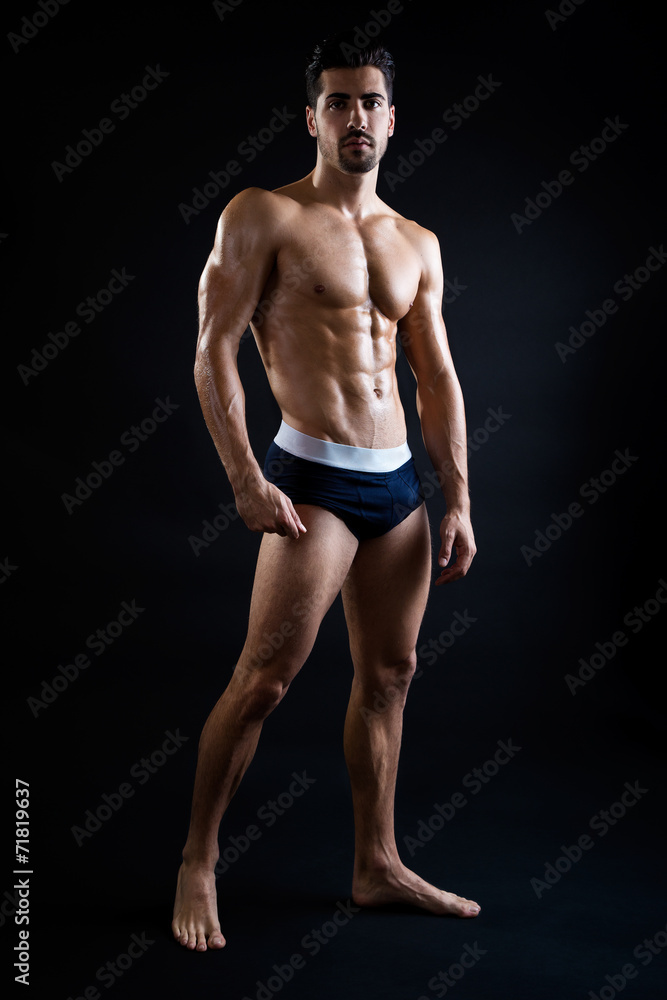 Beautiful and muscular man in dark background.