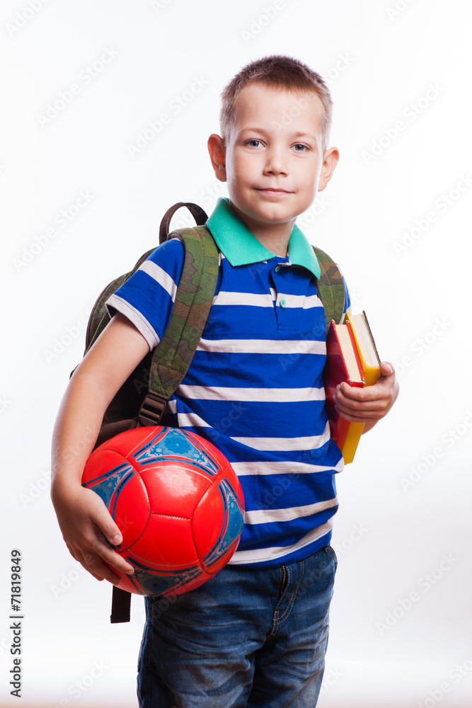Happy schoolboy with backpack, ball and books Happy schoolboy with backpack, ball and books