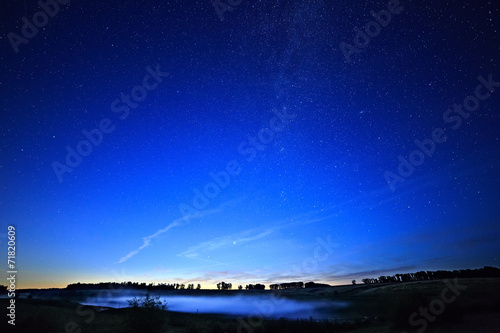 Dawn on a starry background sky and the Milky Way. © lexuss