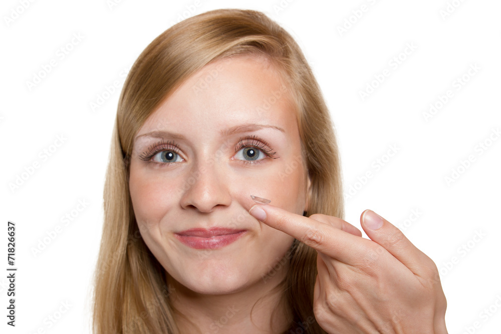 Close-up of blue woman eye with contact lens applying Close-up of blue woman eye with contact lens applying