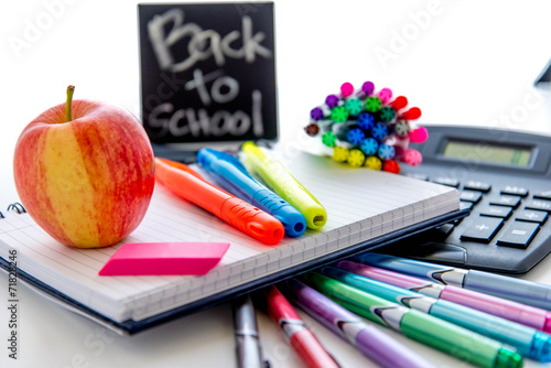 back to school supplies and an apple for the teacher