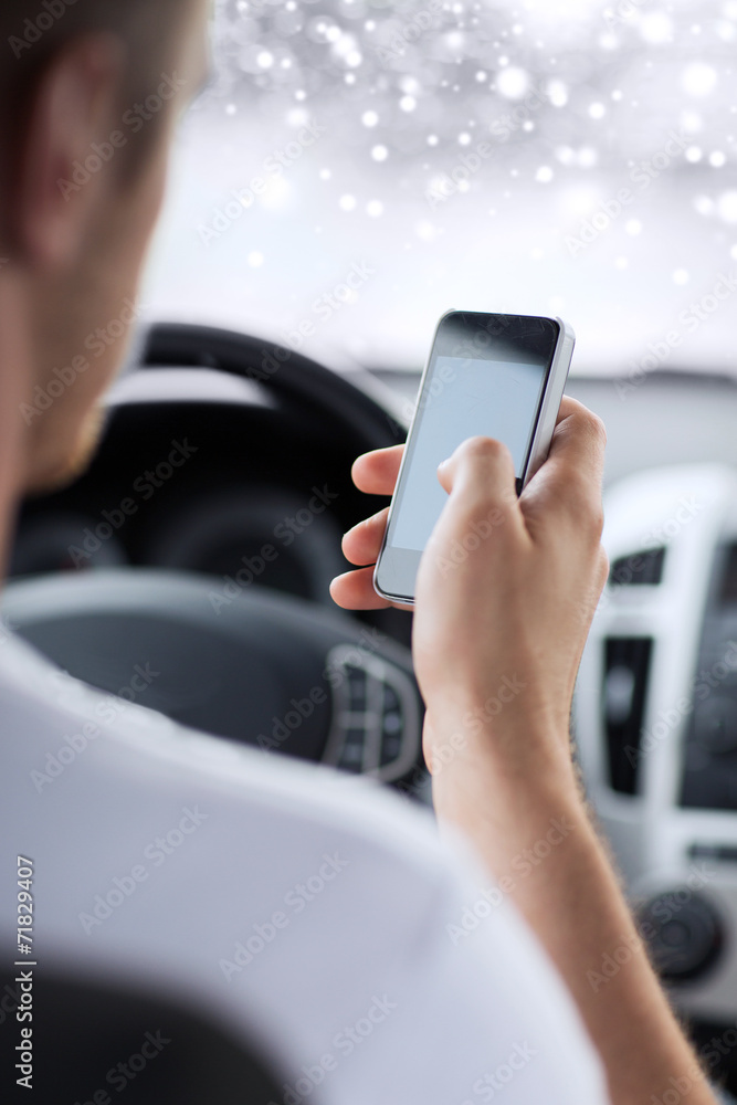 close up of man using smartphone while driving car