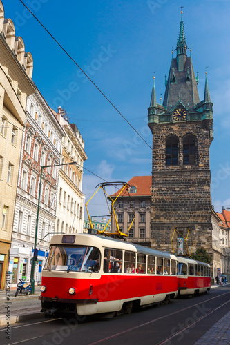 Red retro tram near Jindrisska Tower in Prague, Czech