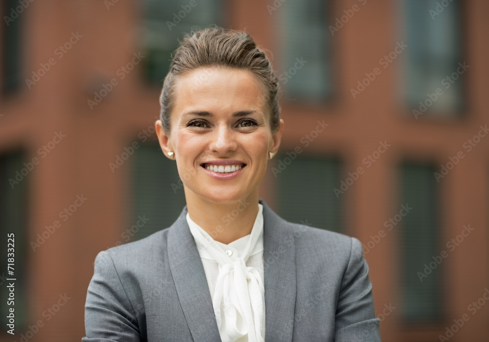 Portrait of happy business woman in front of office building Portrait of happy business woman in front of office building