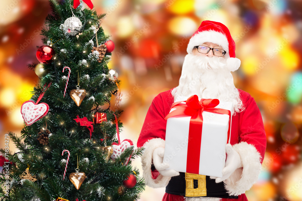 man in costume of santa claus with gift box