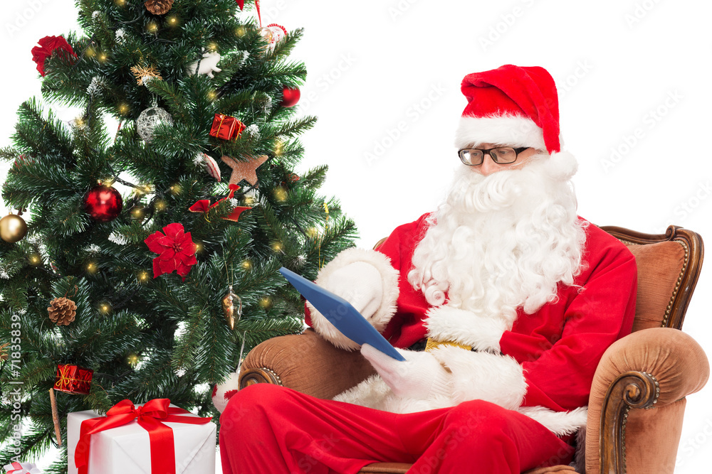 man in costume of santa claus with tablet pc man in costume of santa claus with tablet pc