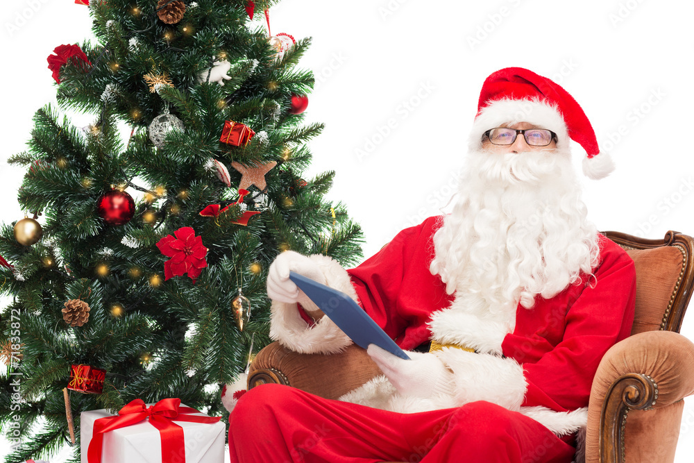 man in costume of santa claus with tablet pc man in costume of santa claus with tablet pc