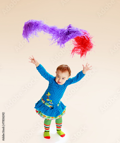 little girl shows up colorful tinsel.