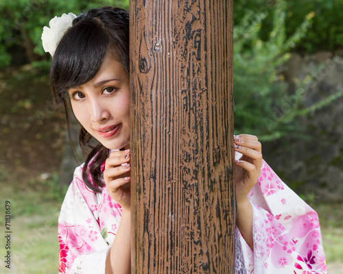 Asian woman in kimono behind wooden pillar © imagesbykenny