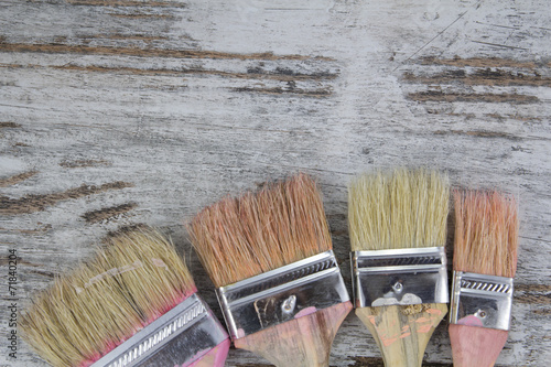 Set of paintbrushes in a wood background photo