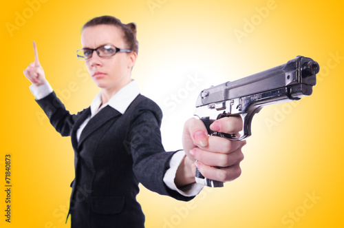 Woman with gun isolated on white