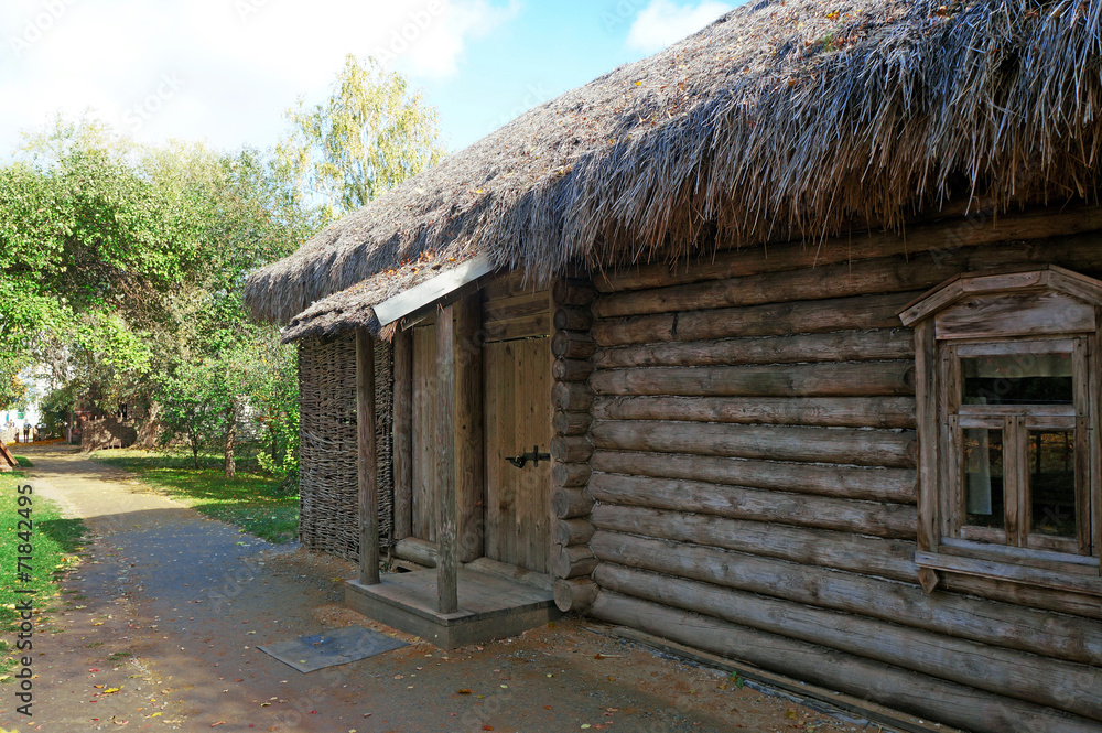 Fragment of Russian wooden log houses with thatched roof Fragment of Russian wooden log houses with thatched roof