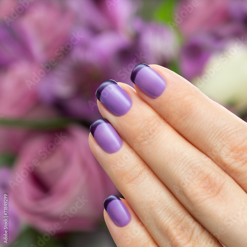 Beautiful manicure, polish is a violet color.