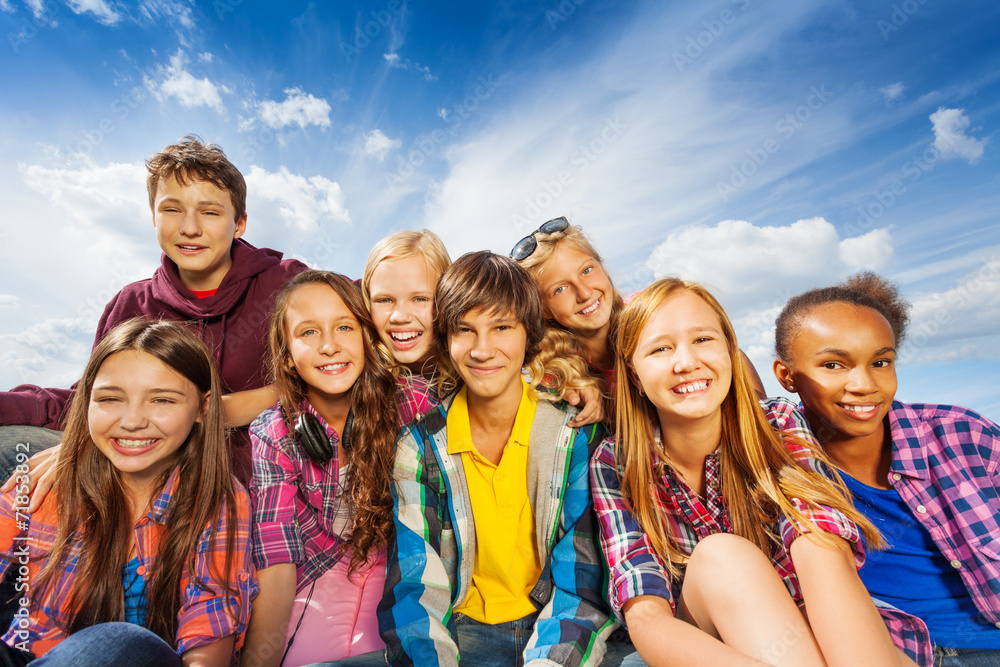 Group of children sitting together and smile Group of children sitting together and smile