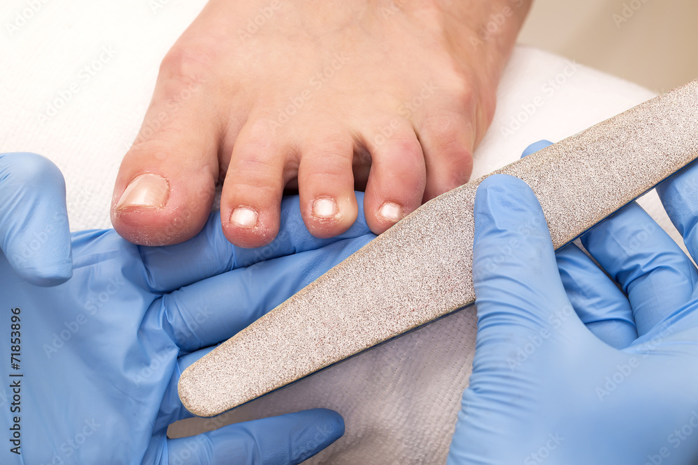 Fototapeta premium process of pedicure at beauty salon
