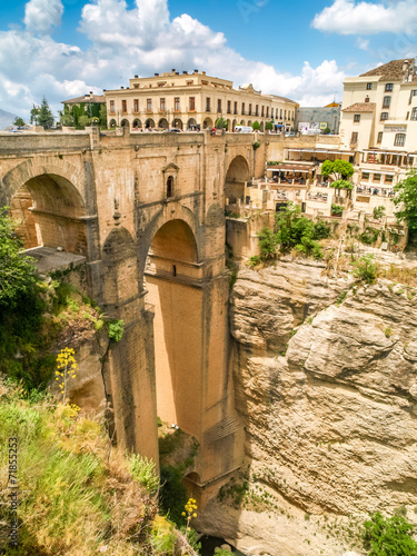view of buildings over cliff in ronda, spain photo