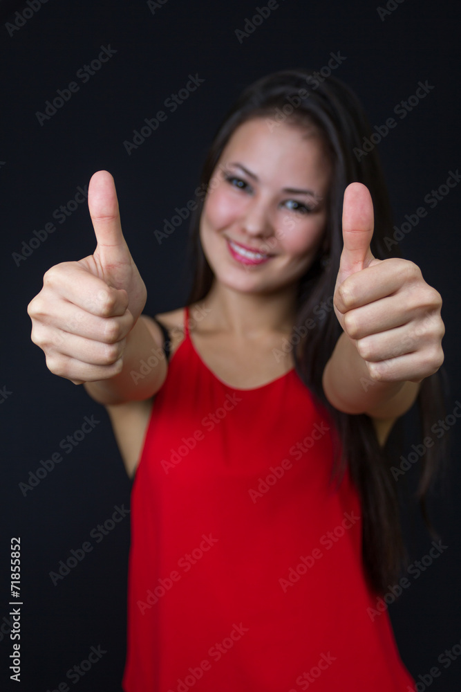 young asian girl making the thumbs up sign young asian girl making the thumbs up sign