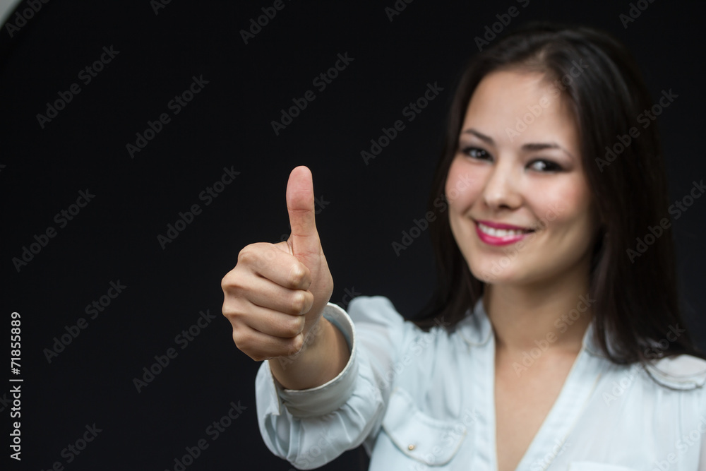 young asian girl making the thumb up sign young asian girl making the thumb up sign