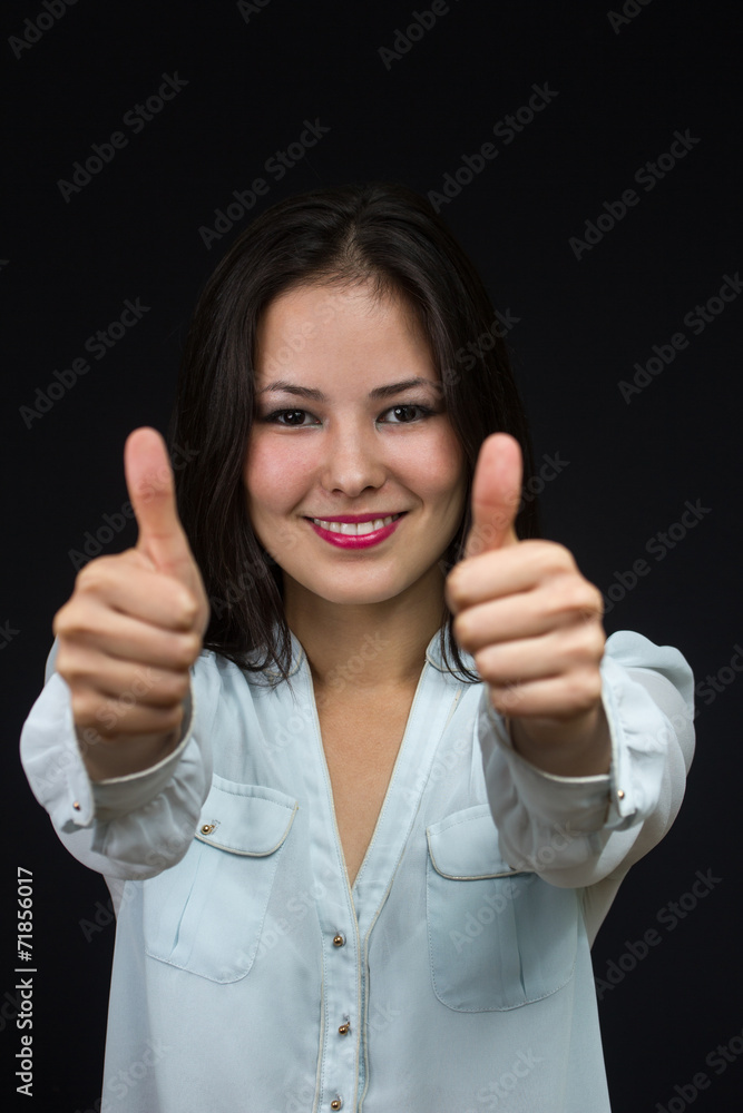 young asian girl making the thumbs up sign young asian girl making the thumbs up sign
