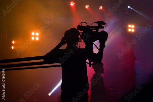 Cameraman silhouette on a concert stage