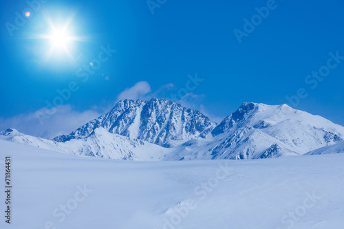 Snow land and rocky mountains © Sergey Novikov