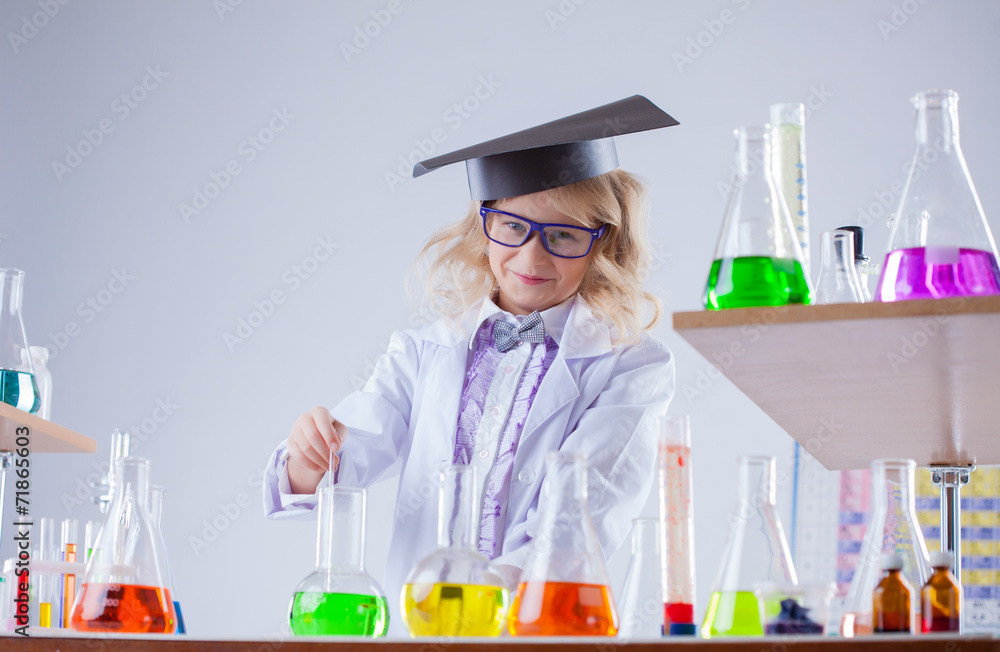 Pretty smiling girl working with reagents in lab Pretty smiling girl working with reagents in lab