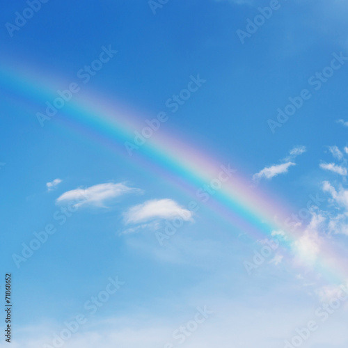 beautiful colorful rainbow on blue sky background