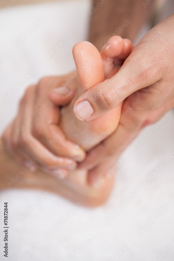 Fototapeta premium Pedicurist massaging a customers foot