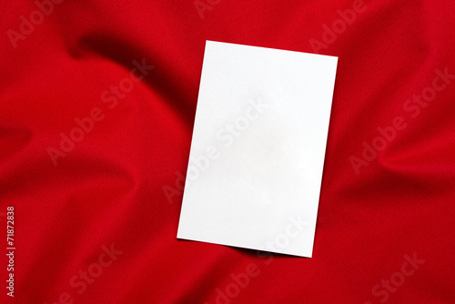 white card on red cloth