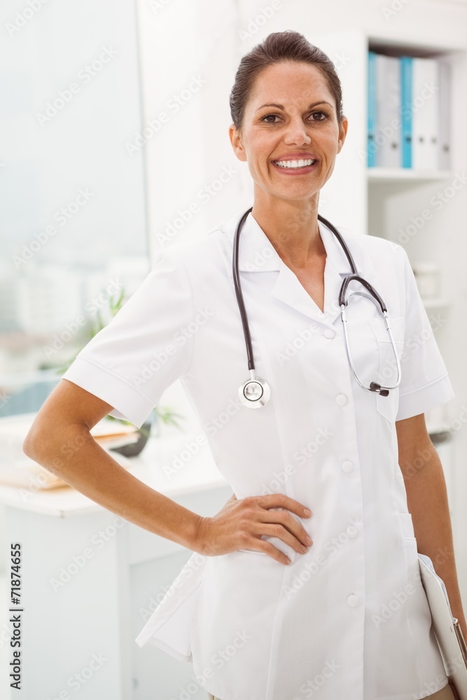 Confident female doctor with stethoscope at medical office Confident female doctor with stethoscope at medical office