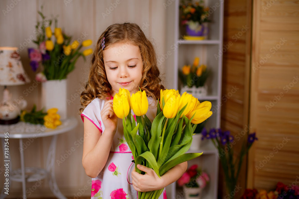 Beautiful girl with yellow tulips