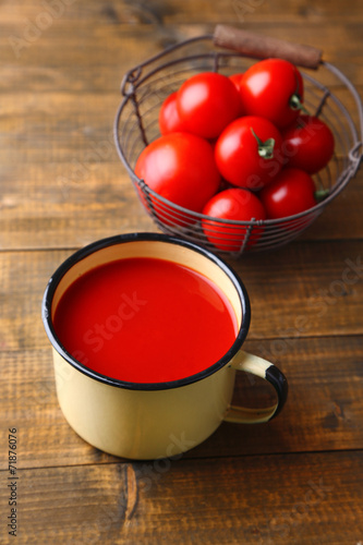 Homemade tomato juice in color mug and fresh tomatoes