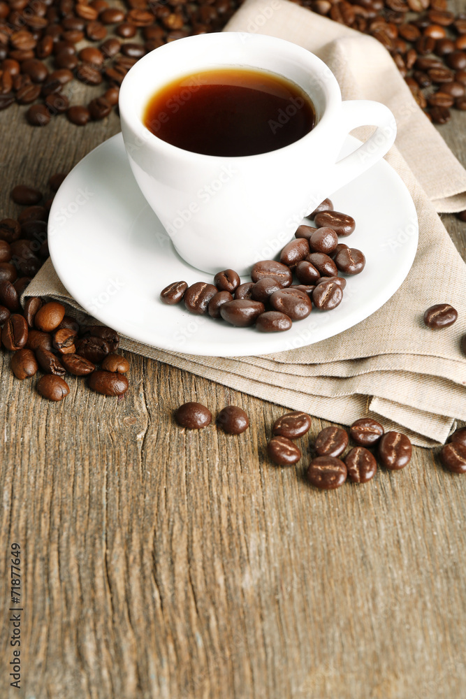 Fototapeta premium Cup of coffee and coffee beans with chocolate glaze