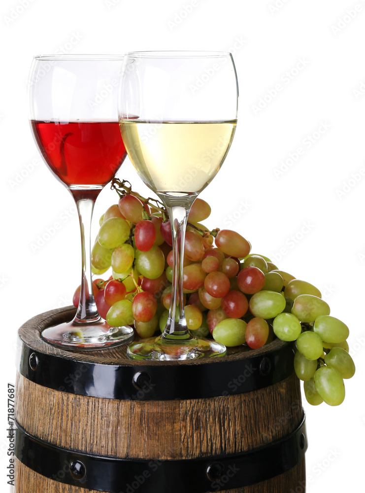 Wine in goblets and grapes on barrel isolated on white
