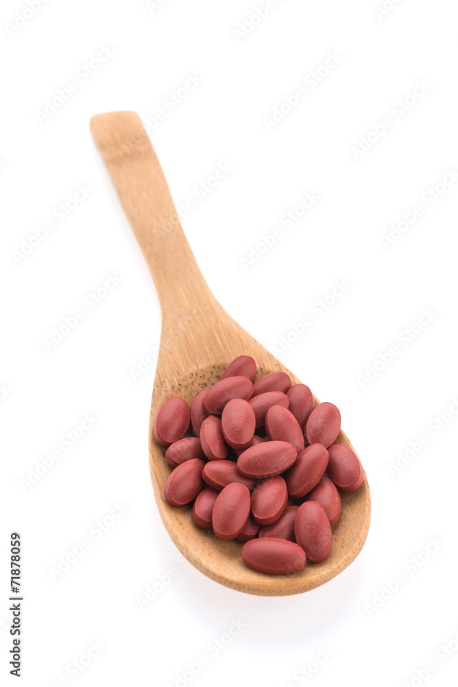 Pill on spoon isolated on white background Pill on spoon isolated on white background