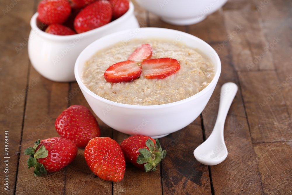 Tasty oatmeal with strawberry on table close-up Tasty oatmeal with strawberry on table close-up