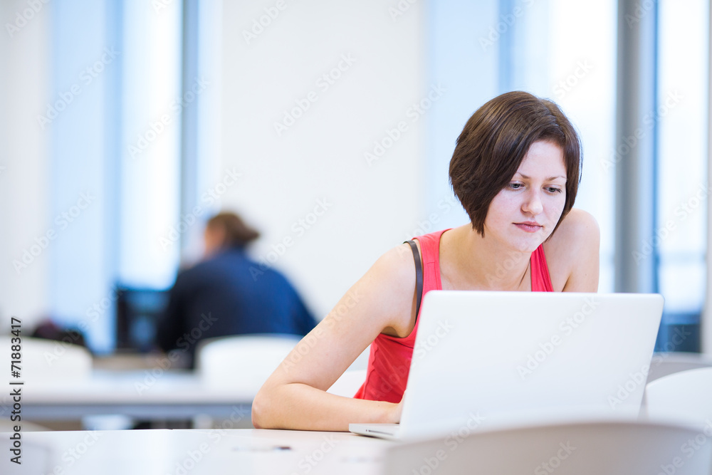 Pretty, young college student studying in the library Pretty, young college student studying in the library