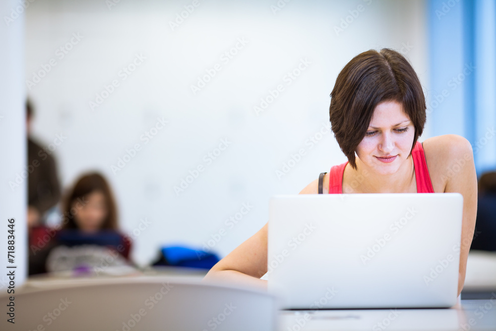 Pretty, young college student studying in the library Pretty, young college student studying in the library