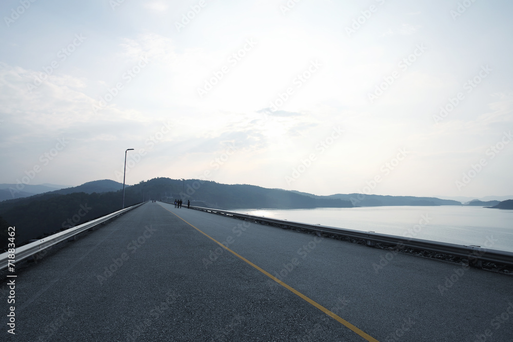 Fototapeta premium People on the road dam