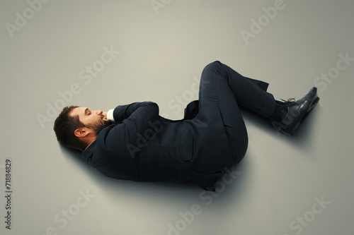 man sleeping on the grey floor © ArtFamily
