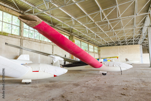 Lightweight gliders stationed inside of a big hangar