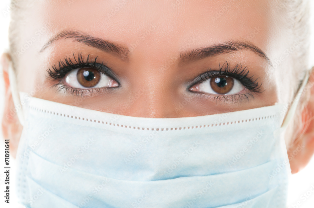 Closeup of the eyes of dentist assistant wearing mask. Closeup of the eyes of dentist assistant wearing mask.