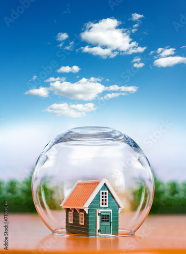 Insured house under glass sphere