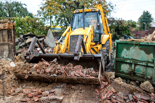 industrial excavator and bulldozer loading debris and demolition