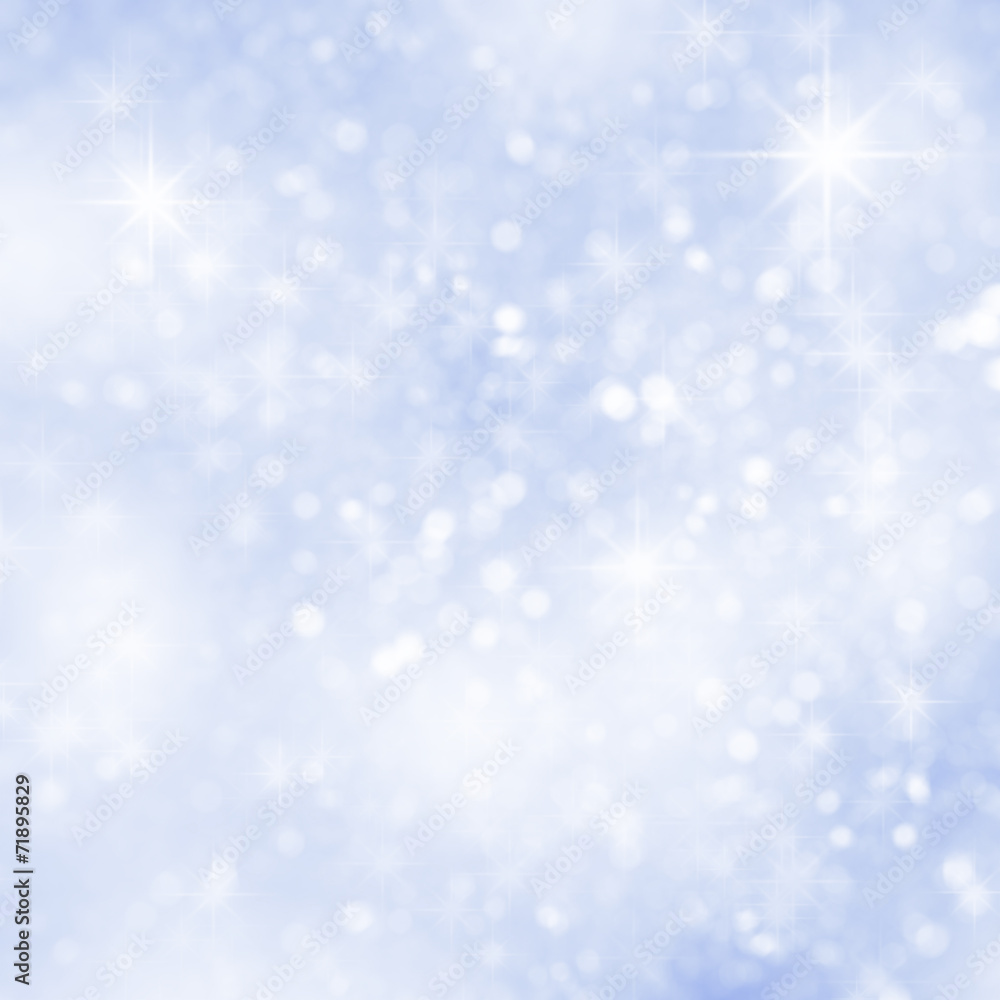 Abstract blue christmas snow background with defocused sparkles.